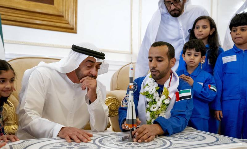 rABU DHABI, UNITED ARAB EMIRATES - October 12, 2019: HH Sheikh Mohamed bin Zayed Al Nahyan, Crown Prince of Abu Dhabi and Deputy Supreme Commander of the UAE Armed Forces (2nd L) looks at a model of the Soyuz MS-15 space ship which launched Hazza Ali Al Mansoori, the first UAE Astronaut (3rd L) to the International Space Station, during a homecoming reception at the Presidential Airport.

( Hamad Al Kaabi / Ministry of Presidential Affairs )​
---