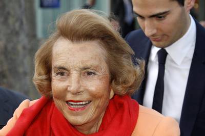 FILE PHOTO: Liliane Bettencourt (L), heiress to the L'Oreal fortune leaves with Jean-Victor Meyers, her grandson, the L'Oreal-UNESCO prize for women in Paris, France, March 29, 2012. REUTERS/Benoit Tessier/File Photo
