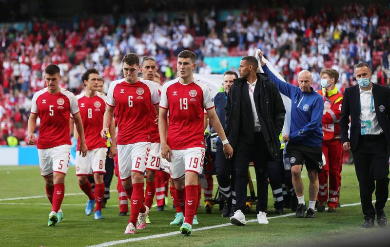 Denmark players head off the pitch as Denmark's Christian Eriksen is carried off. Reuters