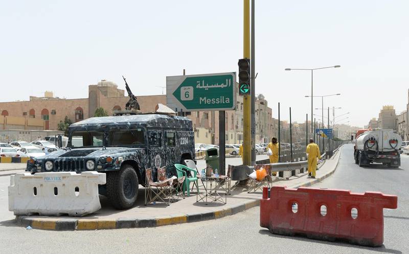 A Kuwaiti police vehicle is seen at the entrance of Jeleeb Al-Shuyoukh street, south of Kuwait City.  EPA
