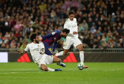 Barcelona's Leo Messi in action against Real Madrid's Marcelo (L) and Raphael Varane (R). EPA