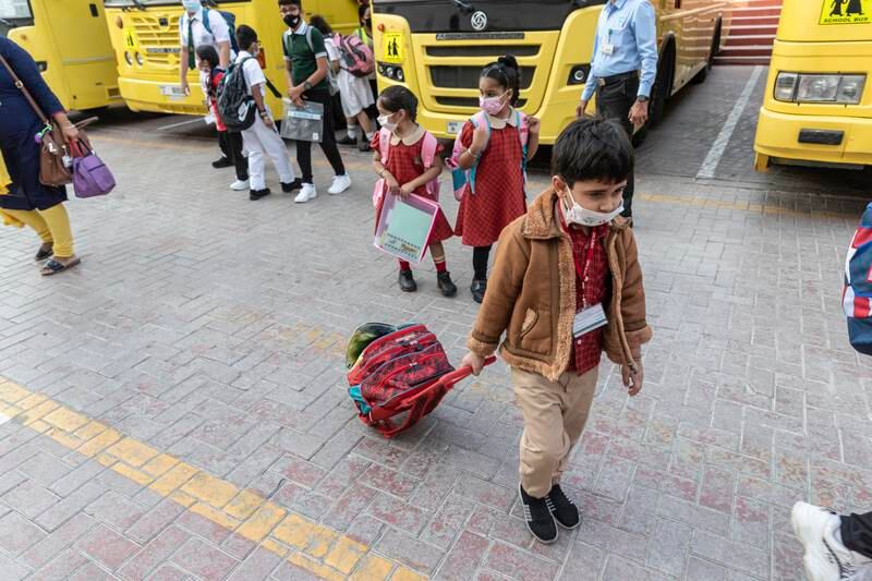 Children arrive at the Delhi Private School for the first day of the new term.