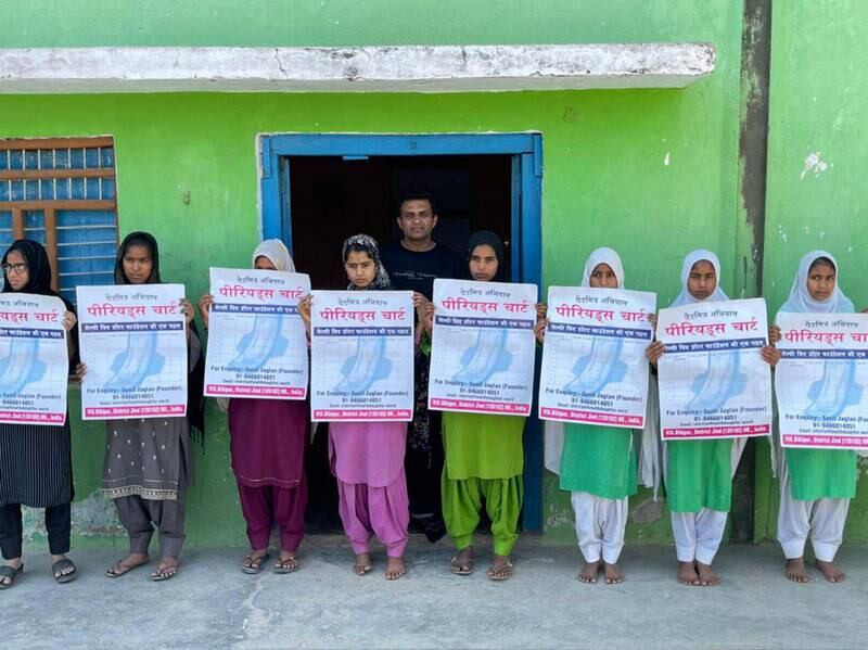 Young women of Nuh, known for poor health infrastructure, dismal literacy rates and consevative society are opening up about menstrual health with their families. They are posing with Sunil Jaglan, the brainchild behind the unique campaign. Taniya Dutta for The National