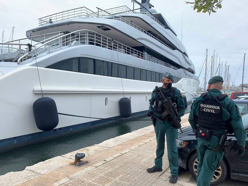 Spanish Civil Guards stand by the Tango superyacht, belonging to Russian oligarch Viktor Vekselberg, which was seized on behalf of US authorities. Photo: Juan Poyates Oliver /  Reuters