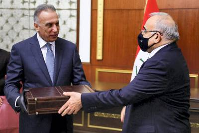 Former Iraqi Prime Minister Adel Abdul Mahdi hands over to new Prime Minister Mustafa al-Kadhimi in Baghdad, Iraq, May 7, 2020. Picture taken May 7, 2020. Iraqi Parliament Media Office/Handout via REUTERS ATTENTION EDITORS - THIS PICTURE WAS PROVIDED BY A THIRD PARTY.