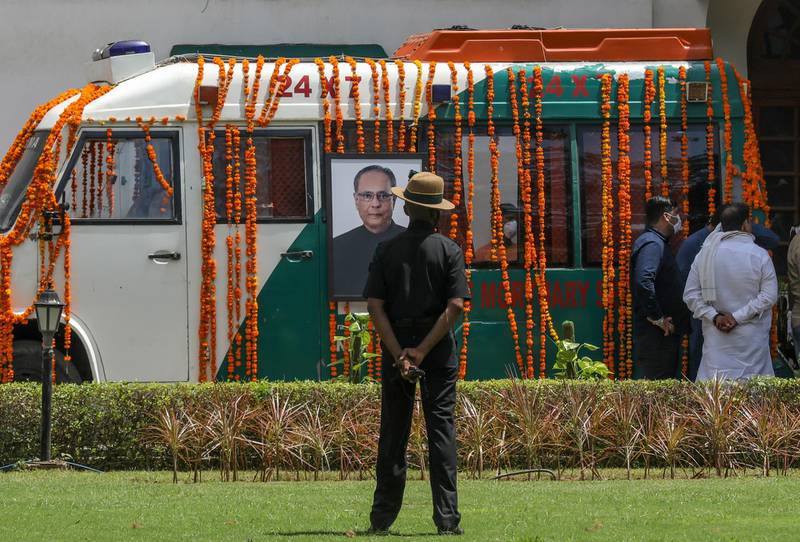 An Indian soldier stands near an ambulance decorated to carry the mortal remains of Mukherjee. EPA