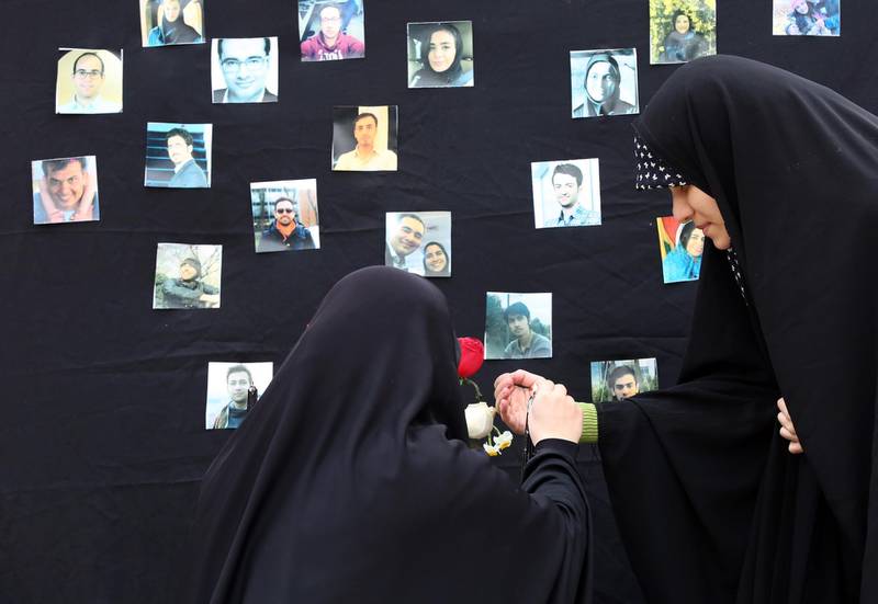 Students light candles during a memorial ceremony for passengers of Ukraine airplane, at the Tehran university in Iran. EPA