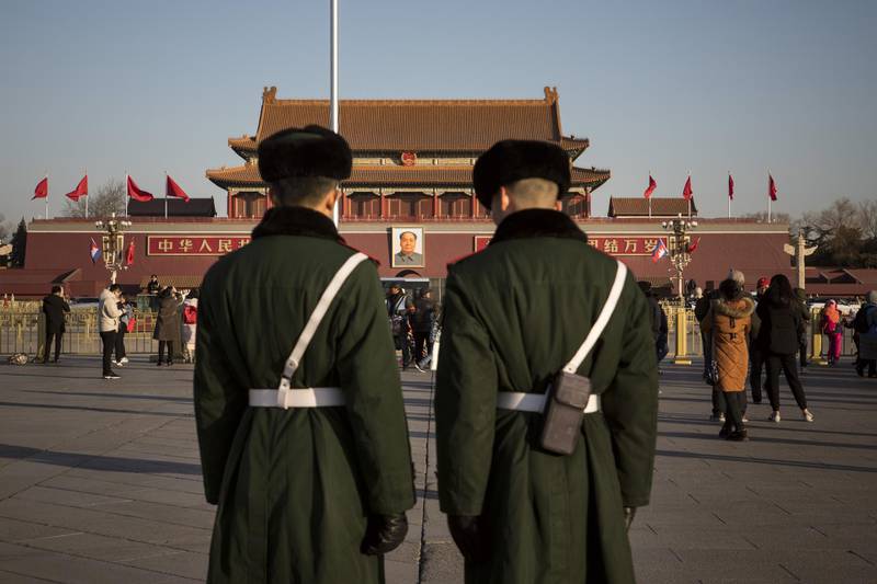 Members of the Chinese People's Armed Police stand guard as a portrait of former Chinese leader Mao Zedong is seen at Tiananmen Square in Beijing, China, on Tuesday, Jan. 22, 2019. President Xi Jinping stressed the need to maintain political stability in an unusual meeting of China's top leaders -- a fresh sign the ruling party is growing concerned about the social implications of the slowing economy. Photographer: Giulia Marchi/Bloomberg