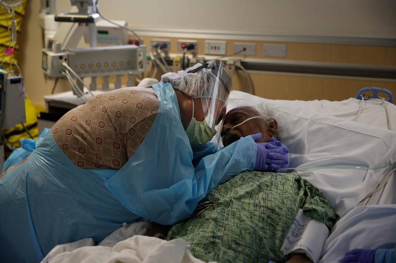 Romelia Navarro, 64, weeps while hugging her husband, Antonio, in his final moments in a Covid-19 unit at St Jude Medical Centre in Fullerton, California, on July 31, 2020.  AP Photo