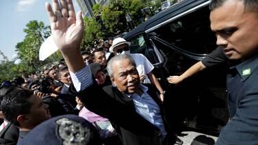Former Malaysian prime minister Muhyiddin Yassin waves outside Kuala Lumpur Court Complex. Reuters