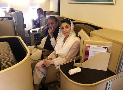 Ousted Pakistani Prime Minister Nawaz Sharif and his daughter Maryam sit on a Lahore-bound flight due for departure, at Abu Dhabi International Airport, on July 13, 2018. Reuters