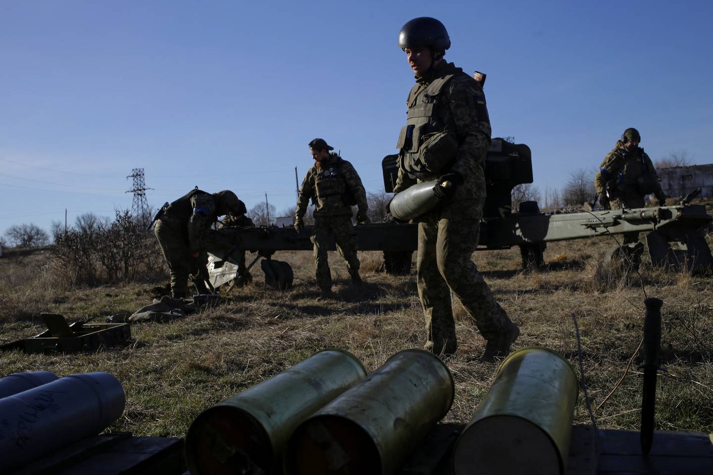 Members of the Ukrainian Volunteer Corps prepare a howitzer, as Russia's attack on Ukraine continues. Reuters