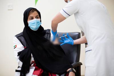 A Dubai ambulance worker is vaccinated with the Pfizer-BioNtech vaccine in Dubai.