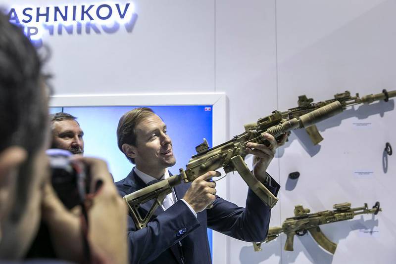 Denis Manturov, the Russian minister of trade and industry, checks out one of the assault rifles at the Kalashnikov Group stand at the International Defense Exhibition & Conference. Silvia Razgova / The National