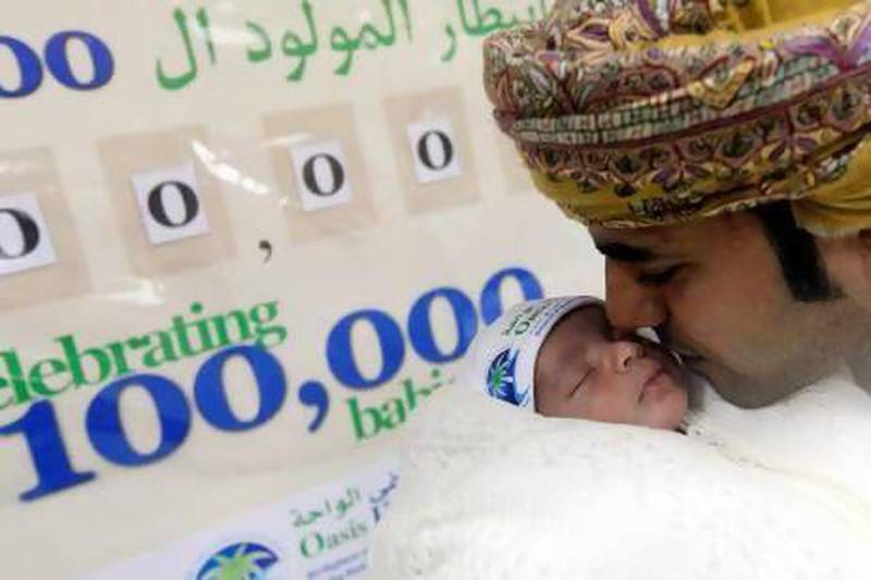 Ahmed Al Omeri with his newborn son Hassan Ahmed, who is the 100,000th baby at the Oasis Hospital in Al Ain. Satish Kumar / The National