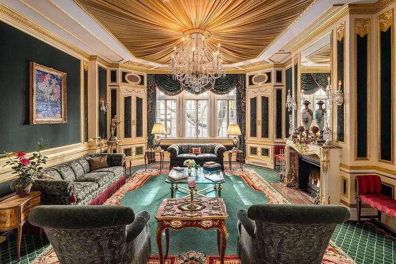 The living room features a gold-embossed marble fireplace and ornate crown mouldings