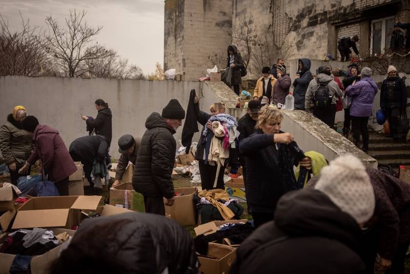 Residents sort through donated clothing at an aid centre in Kherson. Getty