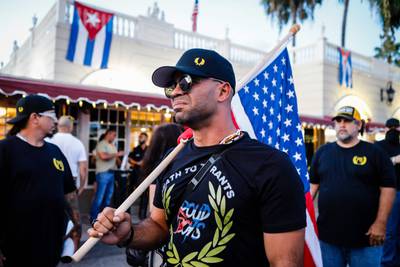 Tarrio holds an American flag during a protest. AFP