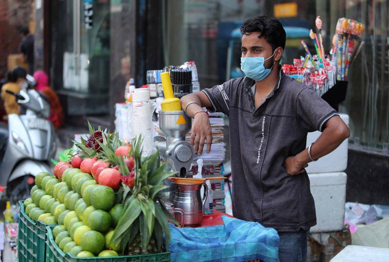 A vendor waits for customers at a market in Jammu, India. AP Photo