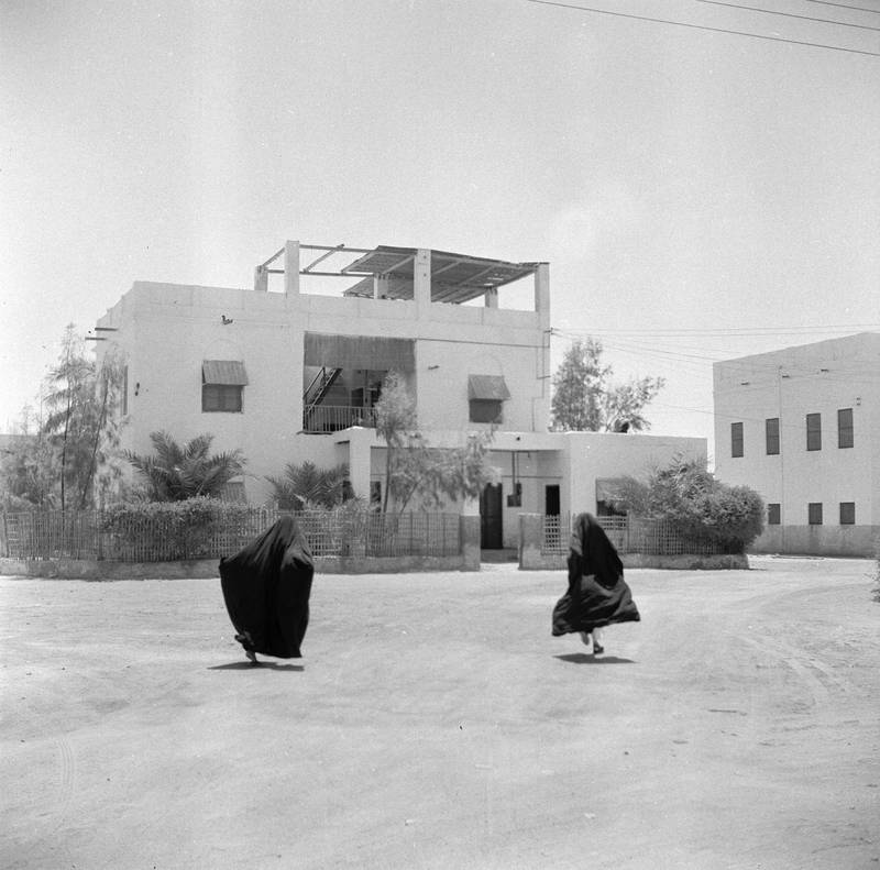 Veiled women flee the ‘evil eye’ of the camera in about 1956 at a housing estate for airport employees.