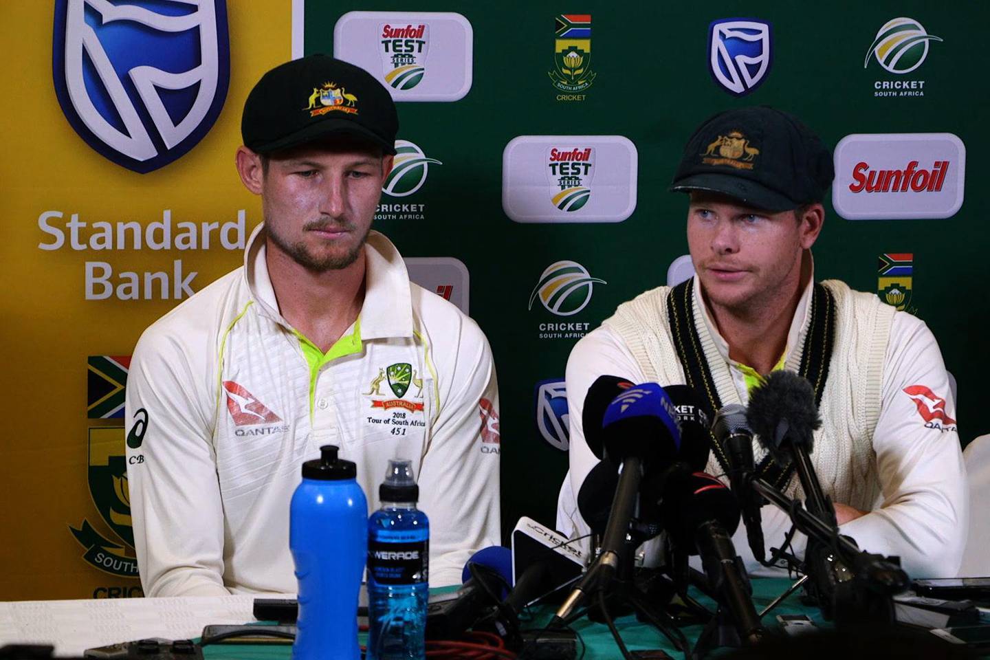 This video grab taken from a footage released by AFP TV shows Australia's captain Steve Smith (R), flankled by teammate Cameron Bancroft, speaking during a press conference in Cape Town, on March 24, 2018 as he admitted to ball-tampering during the third Test against South Africa.
Australia captain Steve Smith and team-mate Cameron Bancroft sensationally admitted to ball-tampering during the third Test against South Africa on March 24, 2018, plunging cricket into potentially its greatest crisis. Bancroft was caught on television cameras appearing to rub a yellow object on the ball, and later said: "I was in the wrong place at the wrong time. I want to be here (in the press conference) because I want to be accountable for my actions." / AFP PHOTO / AFP TV / STR