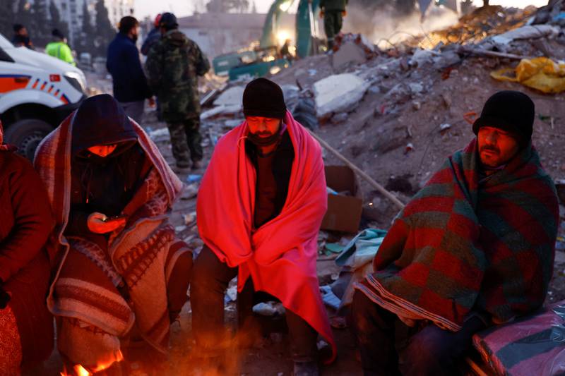 Displaced people keep warm by a fire in Kahramanmaras, Turkey. Reuters