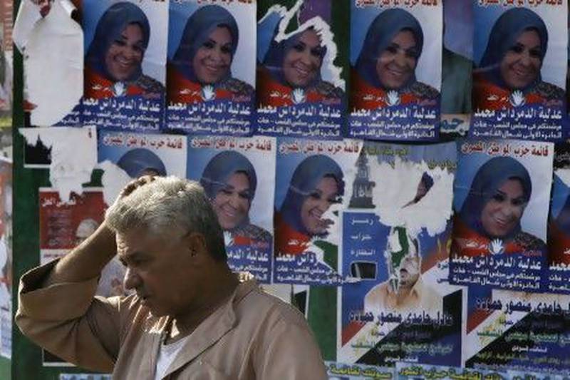 Posters supporting a candidate in the Egyptian parliamentary elections are displayed in Cairo. The election is scheduled to start from Monday. Amr Nabil / AP Photo