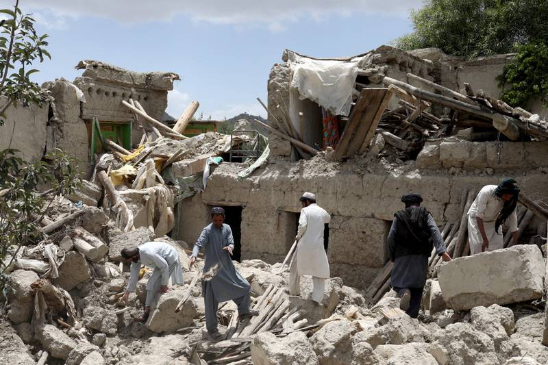 Men search for survivors amid the debris of a house destroyed by an earthquake in Gayan, Afghanistan. Reuters