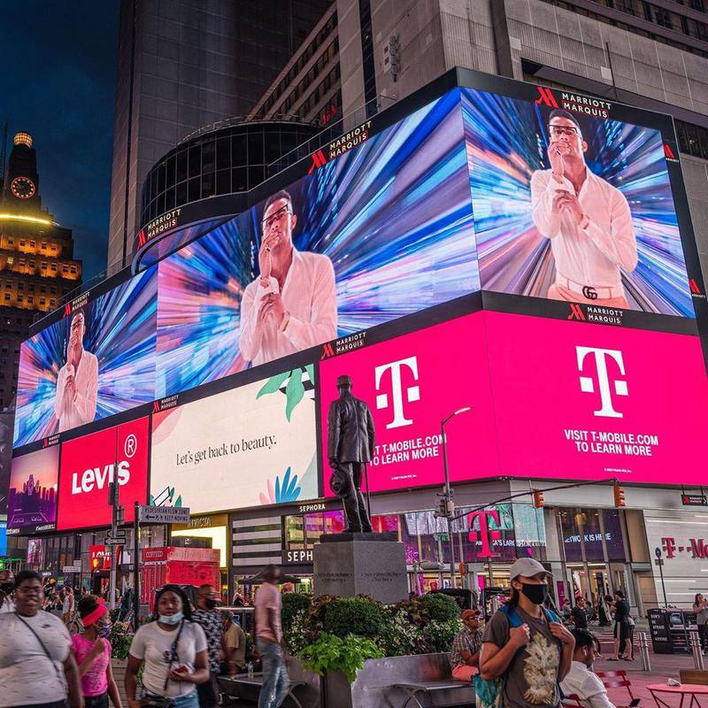 Ramadan's image is projected on to a screen in Times Square, New York.