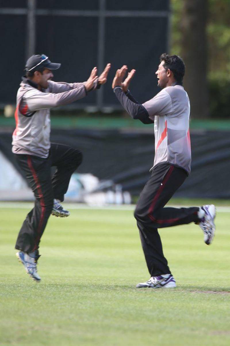 UAE cricket players Khurram Khan and (left) and Amjad Jared celebrates after beating Namibia during the ICC Cricket World Cup Qualifier against Namibia at the Rangiora Oval, Christchurch. 30th January 2014. Image courtesy ICC