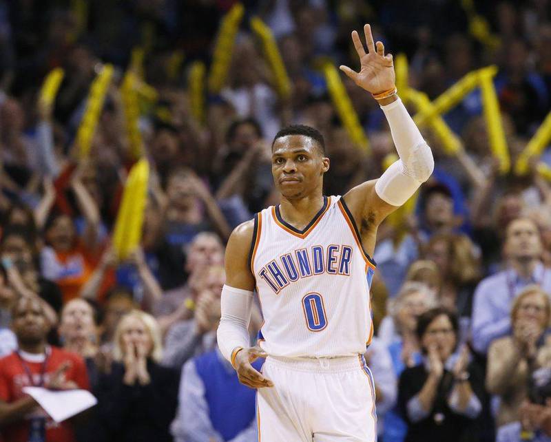 Oklahoma City Thunder guard Russell Westbrook waves to the crowd after tying the record for triple-doubles in a season in the third quarter against the Milwaukee Bucks in Oklahoma City on April 4, 2017. Sue Ogrocki / AP
