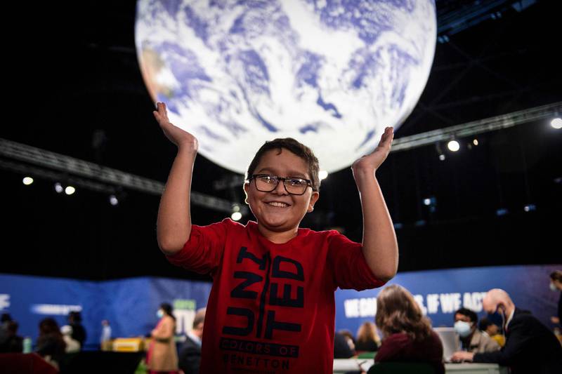 Colombian climate activist Francisco Javier Vera, 12, strikes a cheerful pose at the Cop26 summit, in Glasgow, Scotland. AFP