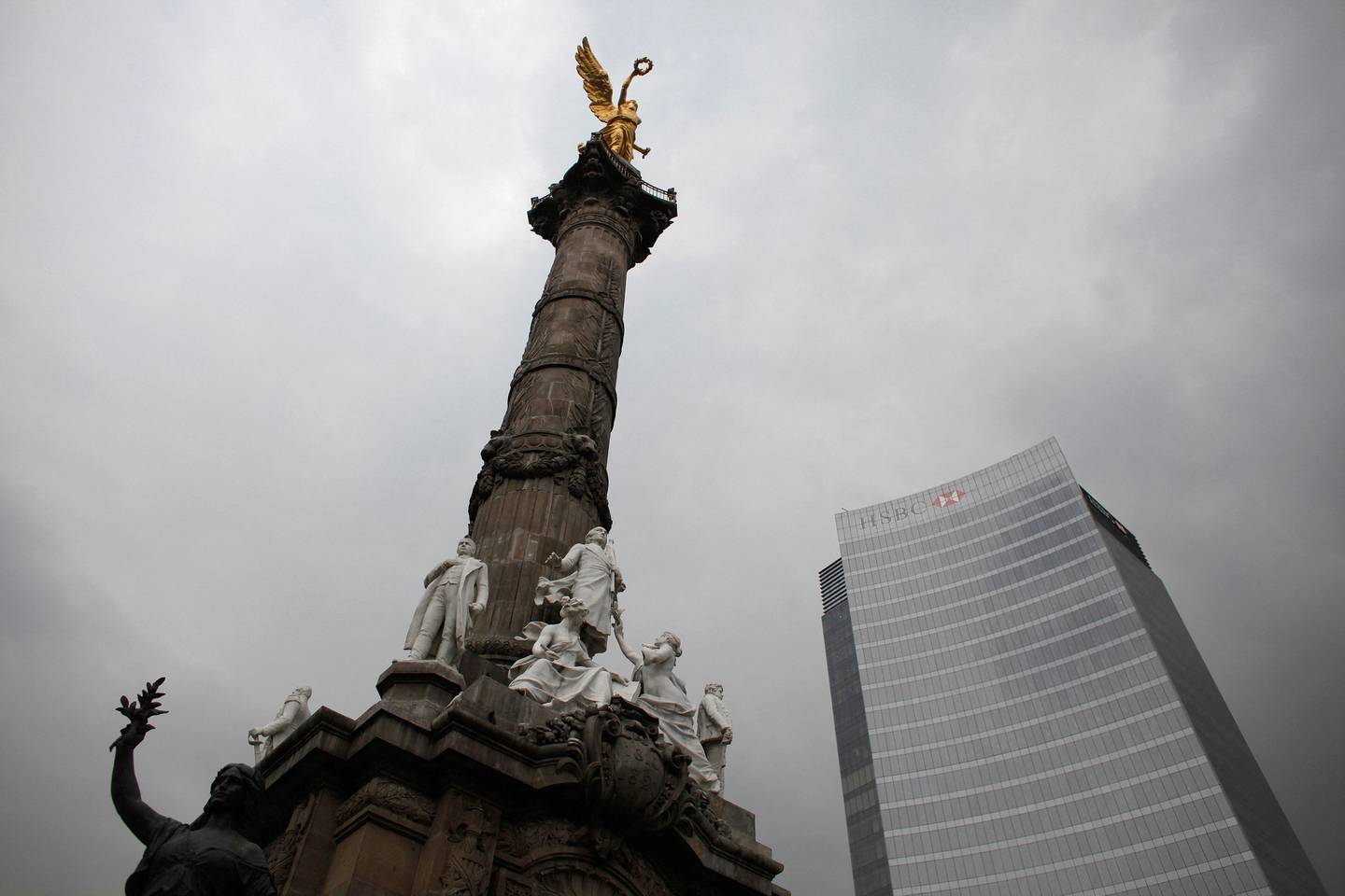 The Angel of Independence monument stands next to HSBC's headquarters in Mexico City. Reuters