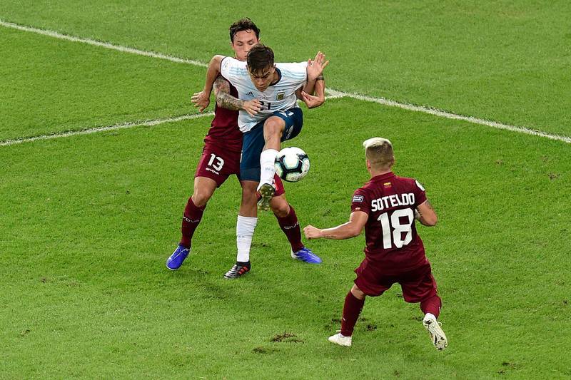 Argentina forward Paulo Dybala fights for the ball with Luis Manuel Seijas of Venezuela. Getty Images