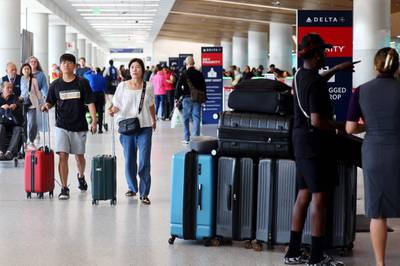 Travellers pass through the Delta terminal at Los Angeles International Airport. The International Air Transport Association said the post-Covid recovery momentum continued in July amid higher passenger traffic. AFP