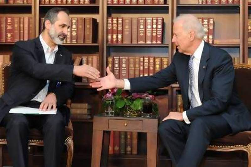 Joe Biden, the US vice president, meets Mouaz Al Khatib, president of the Syrian National Coalition opposition alliance, in Germany in 2013. EPA