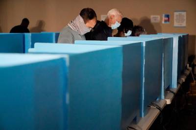People cast their votes in a spotlight from a generator during early voting at the Dunwoody Library after Hurricane Zeta knocked out power in the surrounding areas in Dunwoody, Georgia. AP Photo