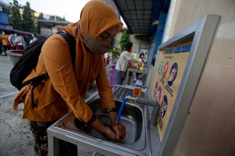 A teacher washes her hands at a school in Banda Aceh, Aceh, Indonesia. EPA