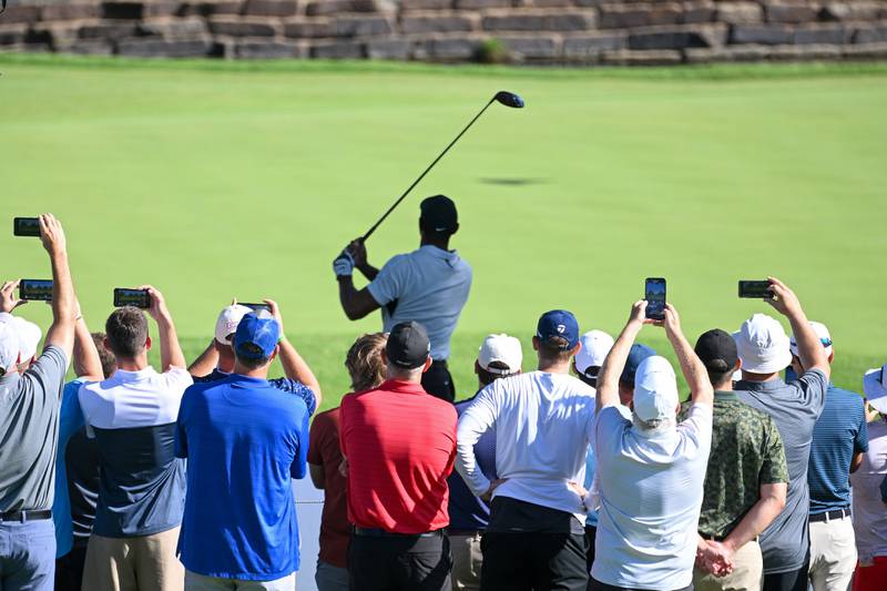 Fans watch Tiger Woods plays his shot from the 12th tee during a practice round prior to the start of the 2022 PGA Championship. Getty
