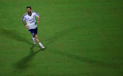 Messi enjoys a run during training. EPA