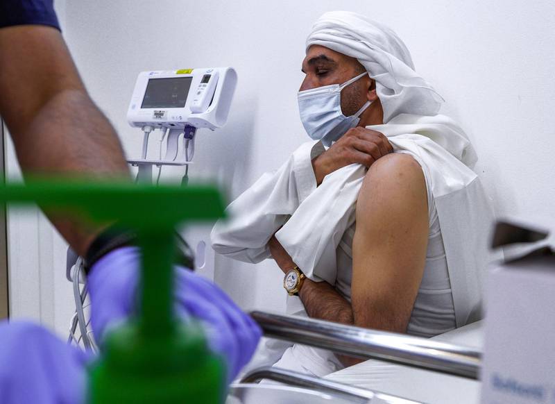 Abu Dhabi, United Arab Emirates, January 12, 2021. SEHA Vaccination Centre at the Abu Dhabi Cruise Terminal area.  Abdulaziz Karmastaji gets vaccinated.
Victor Besa/The National
Section:  NA
Reporter:  Shireena Al Nowais