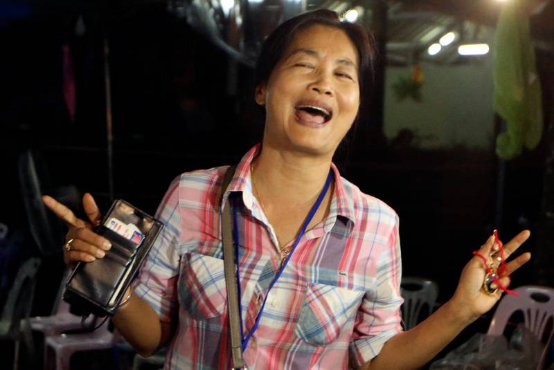 A family member smiles after hearing the news that the missing 12 boys and their soccer coach have been found, in Mae Sai, Chiang Rai province, in northern Thailand, on July 2, 2018. Sakchai Lalit / AP Photo