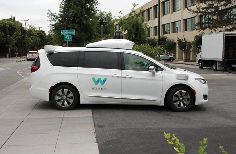 A Waymo self-driving car pulls into a parking lot at the Google-owned company's headquarters in Mountain View, California, on May 8, 2019. (Photo by Glenn CHAPMAN / AFP)