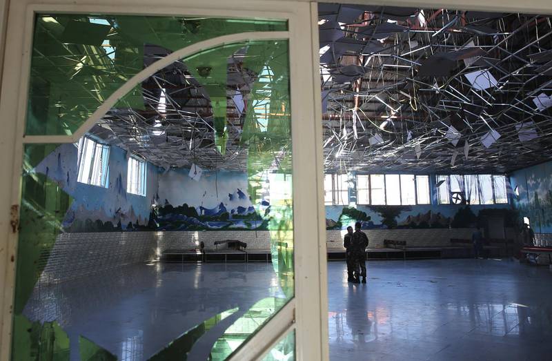 Afghan soldiers inspect a damaged Dubai City wedding hall after an explosion in Kabul, Afghanistan.  AP