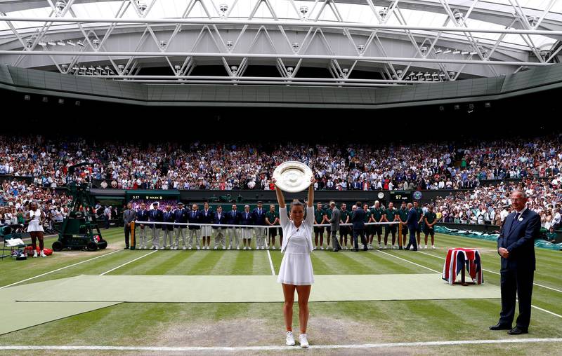 Simona Halep of Romania celebrates with the trophy on Centre Court after beating Serena Williams of the USA. EPA