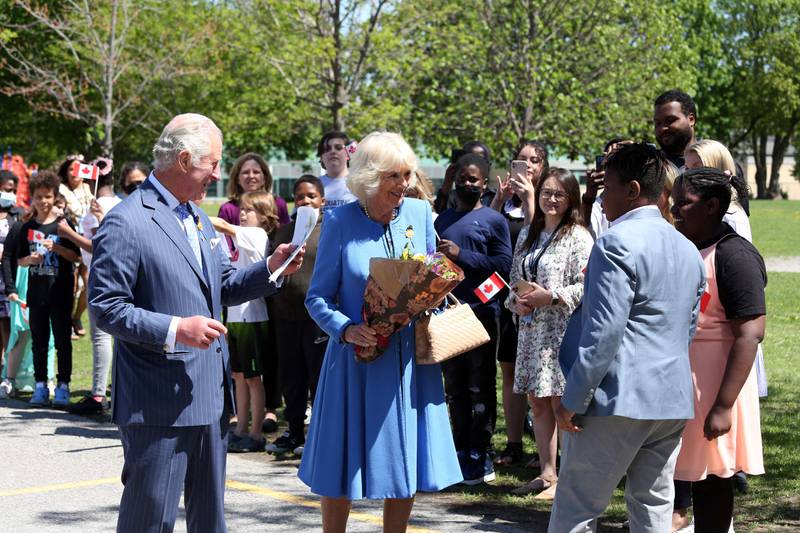 Britain's Prince Charles and Camilla, Duchess of Cornwall greet students during a visit at Assumption Catholic school in Ottawa. AFP