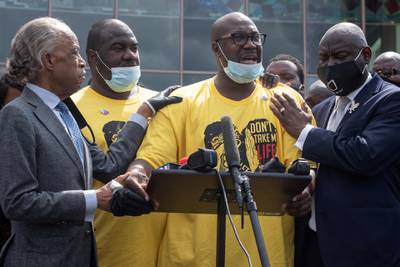 Philonise Floyd, brother of George Floyd, whose death in Minneapolis police custody has sparked nationwide protests against racial inequality, is held by Reverend Al Sharpton and attorney Ben Crump in Houston, Texas. REUTERS