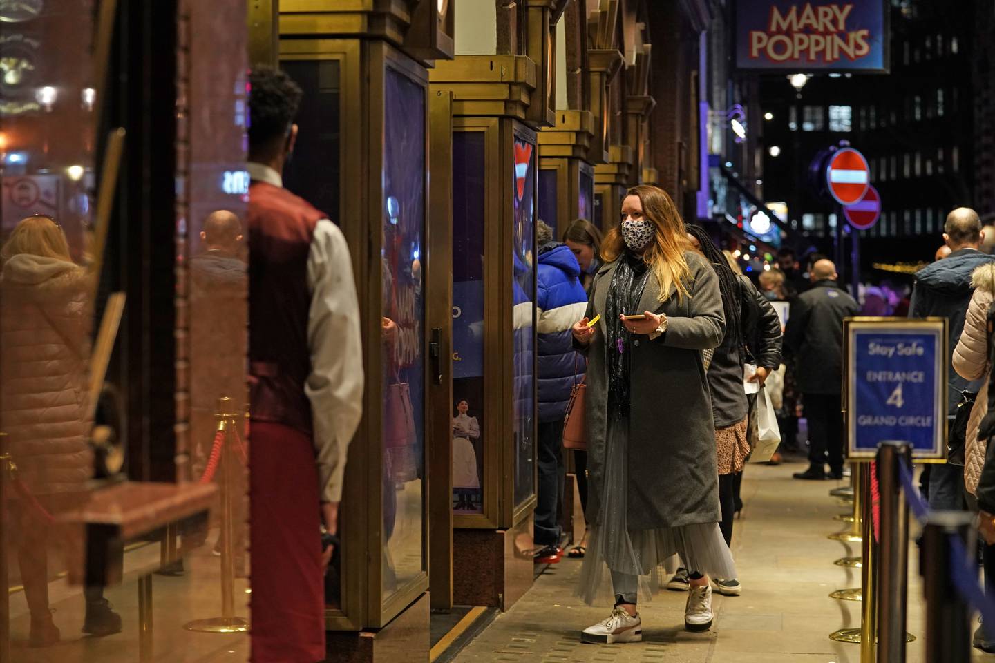 People arriving for the evening performance of 'Mary Poppins' at the Prince Edward Theatre on Old Compton Street, London. PA
