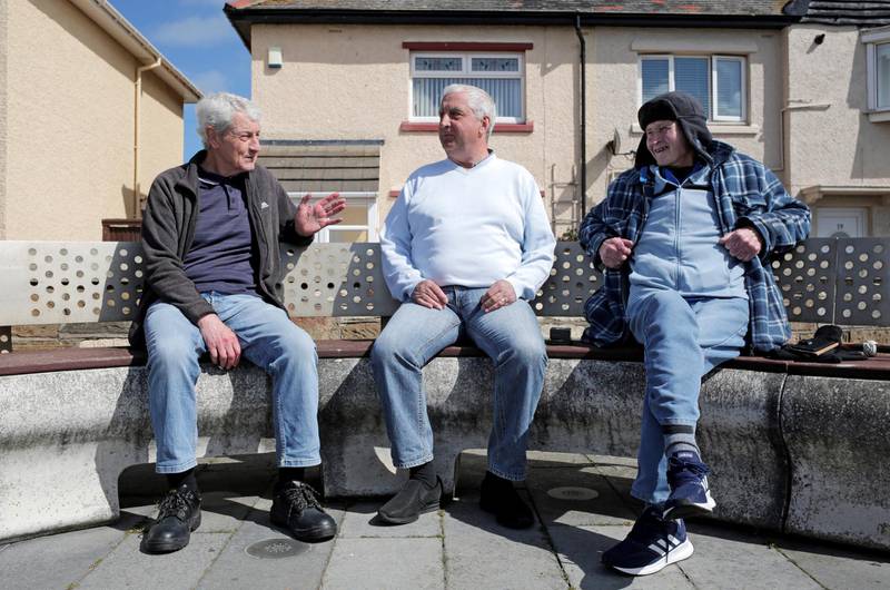 From left, friends Dave Horsley, Dave Latimer and Harry Marsh in conversation at the sea front on Hartlepool's Headland. Photograph: Stuart Boulton 