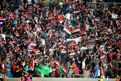 Iraqi and Saudi soccer fans cheer, waving national flags during a friendly soccer match between Iraq and Saudi Arabia in Basra, 550 kilometers (340 miles) southeast of Baghdad, Iraq, Wednesday, Feb. 28, 2018. (AP Photo/Nabil al-Jurani)